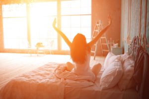 Woman stretching in bed after wake up